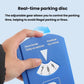 Hand setting the arrival time dial on a blue parking time disc sign