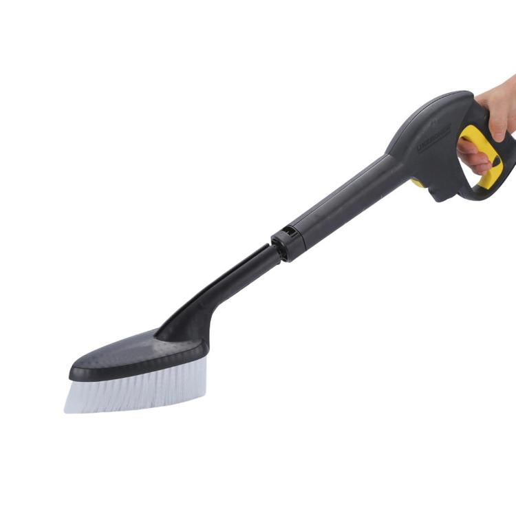 Wheel cleaning brush attachment held in hand, black handle and white bristles
