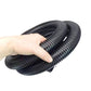 Coiled ribbed vacuum hose held in hand, flexible corrugated design