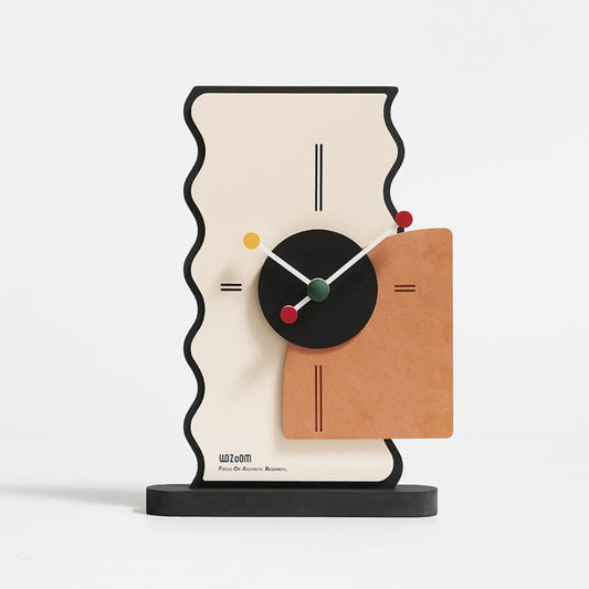 Geometric desk clock with cream back, black center dial, orange panel, and colored markers