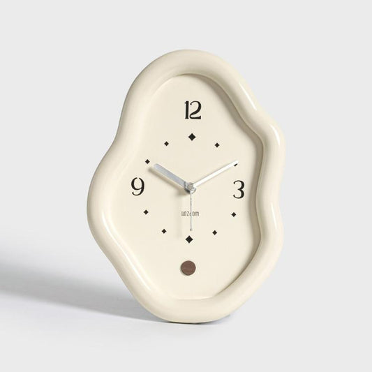 White irregular desk clock with silver hands and diamond hour markers on cream face