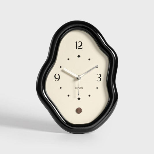 Black irregular desk clock with silver hands and diamond hour markers on cream face