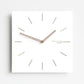 Square wall clock with white face, dark wood hands, minimal line tick markers, angled view