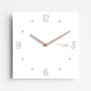 Square wall clock with white face, crossed dark wood hands, hour dots around the frame