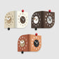 Four dual-dial corner wall clocks in beige, dark brown, and orange color options