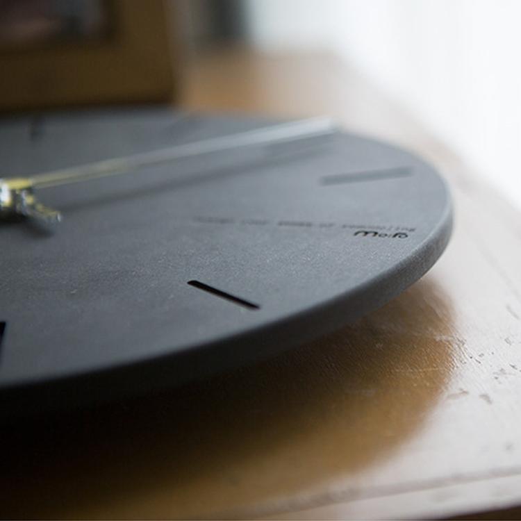 wozoom silent wall clock, close-up angled view of gray dial with black line markers and hands