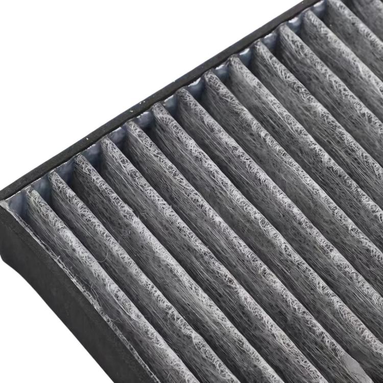 Cabin air filter close-up showing pleated gray fibers in black frame