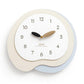 Irregular wall clock with beige frame and light blue outer ring, gold and black hands
