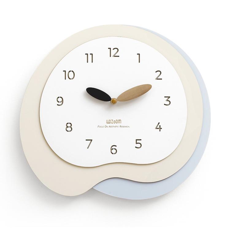 Irregular wall clock with beige frame and light blue outer ring, gold and black hands