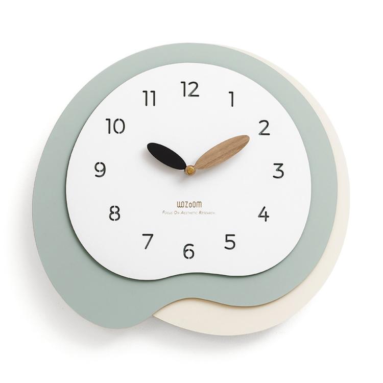 Irregular wall clock with white face, gray-green outer ring, gold and black hands