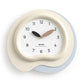 Irregular wall clock with cream frame and light blue outer ring, black and wood hands