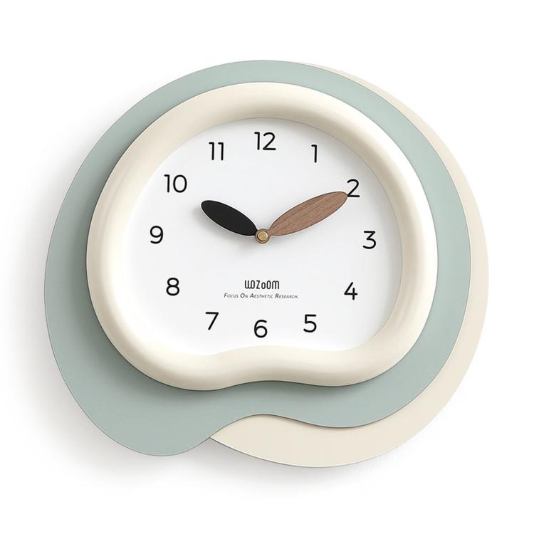 Irregular wall clock with white face, sage-green outer ring, black and wood hands