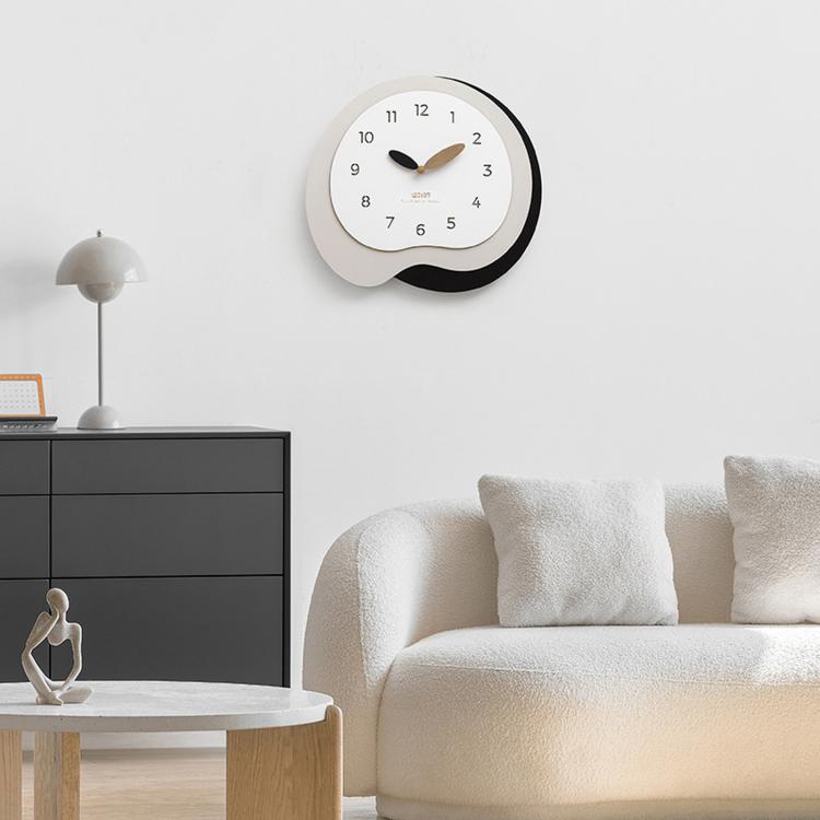 Irregular wall clock with white face, dark outer ring, black and wood hands