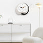 Irregular wall clock with white face, black outer ring, black and wood hands