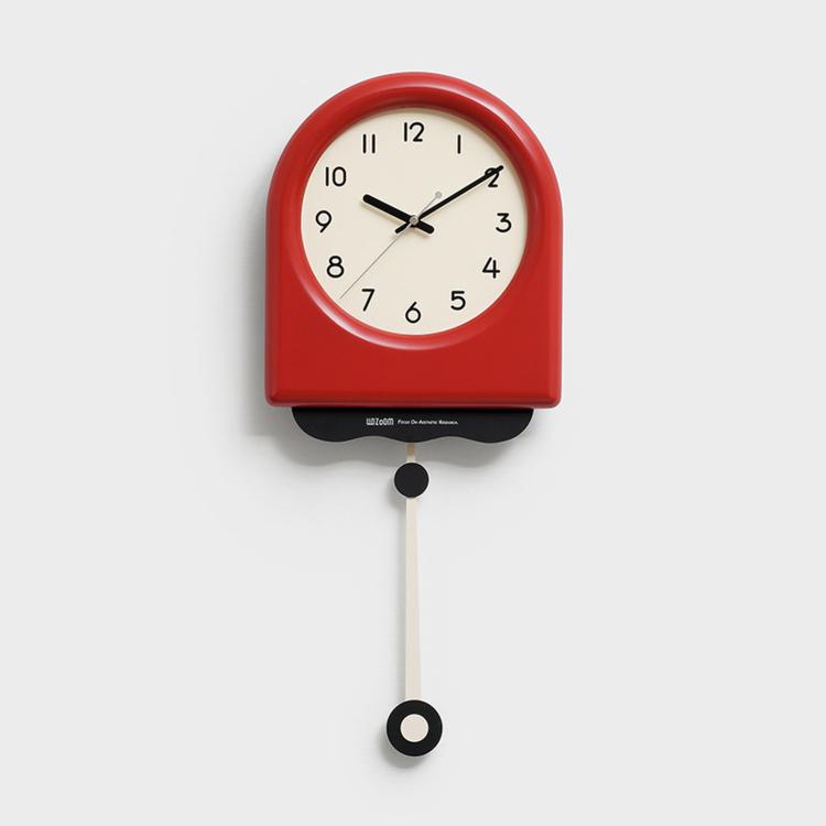 Red pendulum wall clock with cream dial, black hands, and hanging pendulum weight.