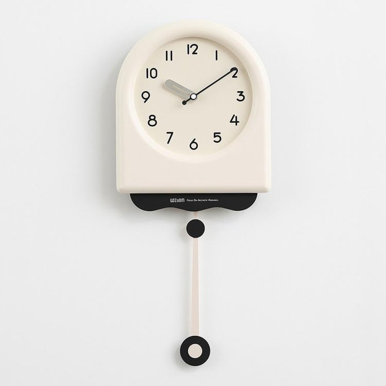 Cream pendulum wall clock with light dial, black hands, and hanging pendulum weight.