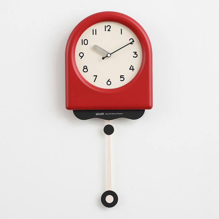 Red pendulum wall clock with cream dial and hanging pendulum weight.