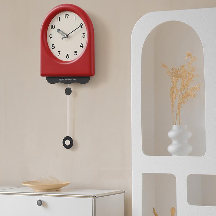 Red pendulum wall clock with cream dial and hanging pendulum weight.