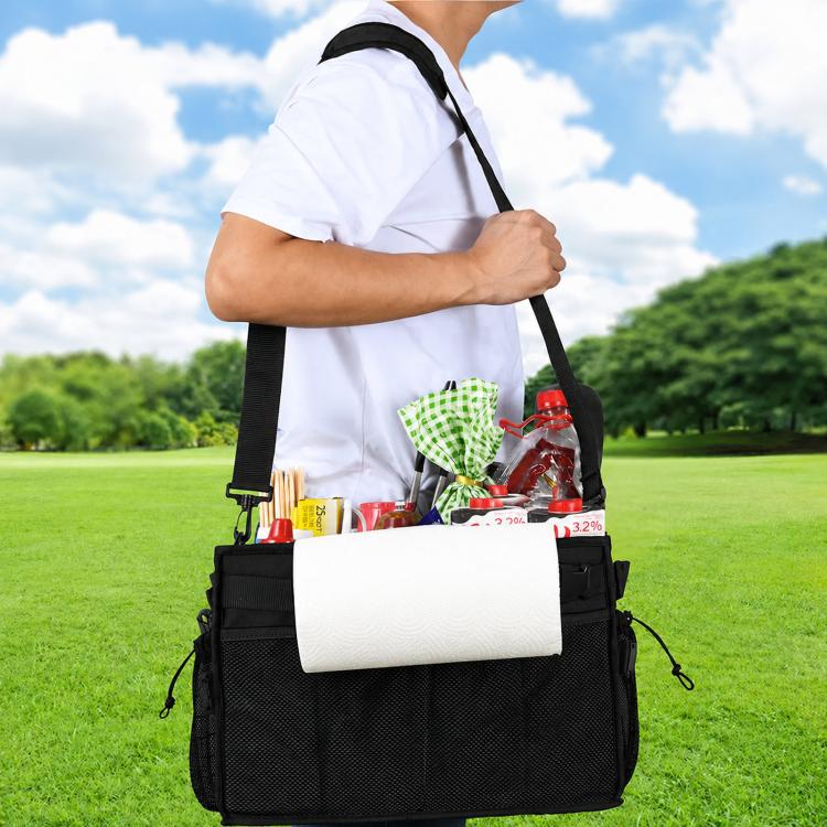 Person carrying outdoor grill storage bag with shoulder strap, front zip pocket