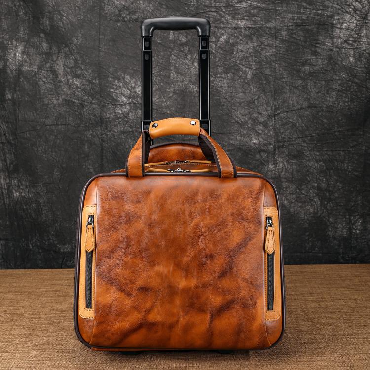 Brown leather rolling briefcase with orange trim and upright pull handle