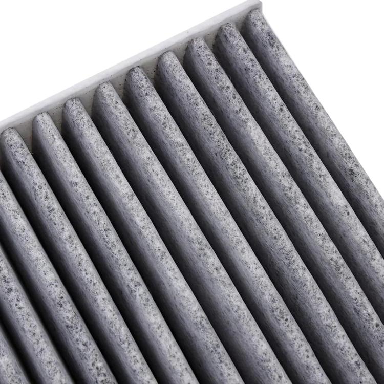 Car air filter element close-up, gray pleats with white plastic edges