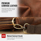 Brown leather crossbody bag close-up with metal swivel hook on the adjustable strap