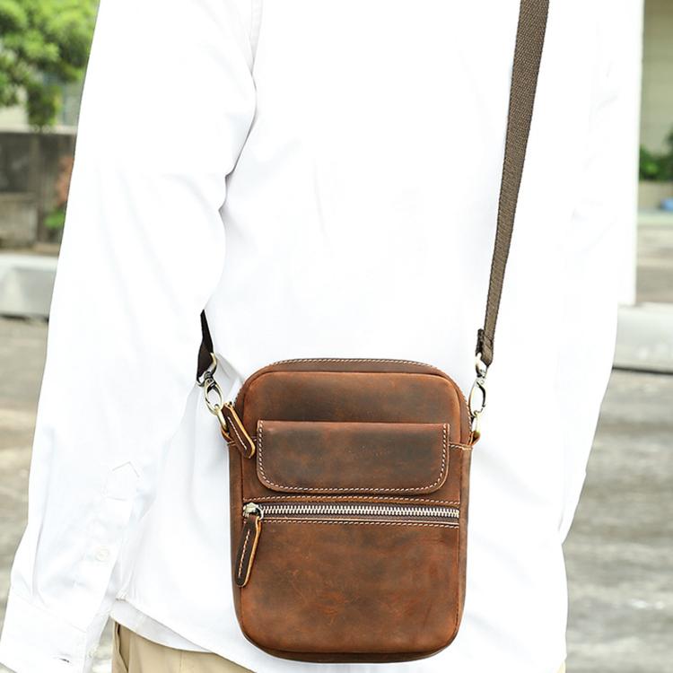 Brown leather crossbody bag worn cross-body, front flap and top zip pocket with strap