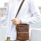 Small vintage leather crossbody bag in brown, front flap and zip with adjustable strap