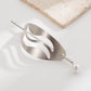 Silver geometric hair bun cuff slide with wavy cutout and pearl end pin