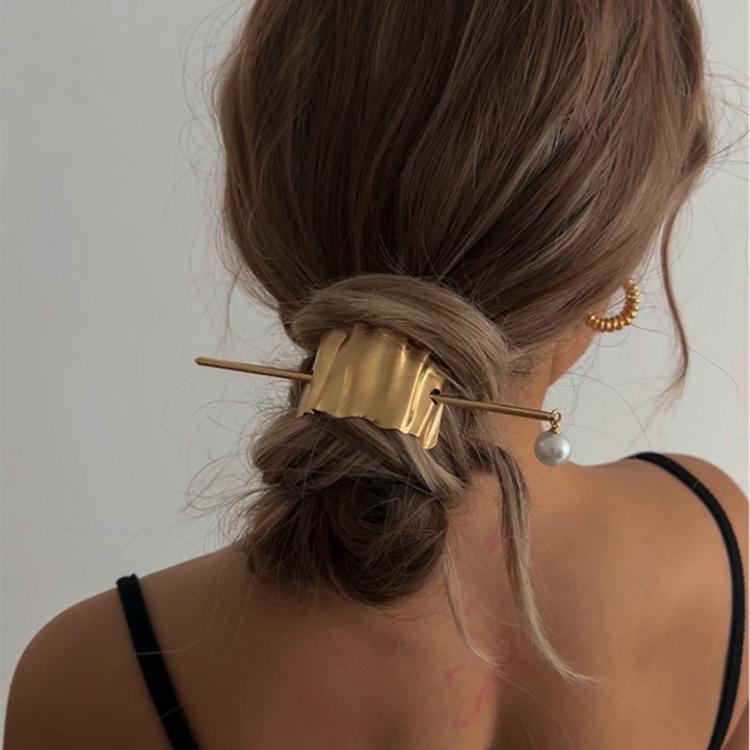 Gold wave hair cuff on bun with pearl drop pin and textured metal slide
