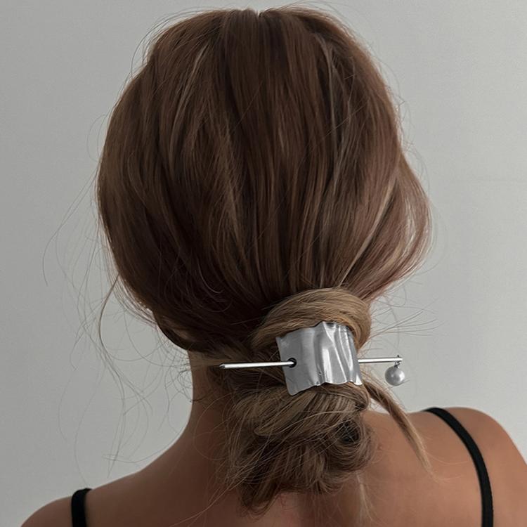 Silver wave hair cuff on bun with pearl drop pin and textured metal slide