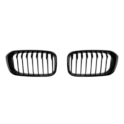 Black oval front grille pair with vertical slats and single-line center bars