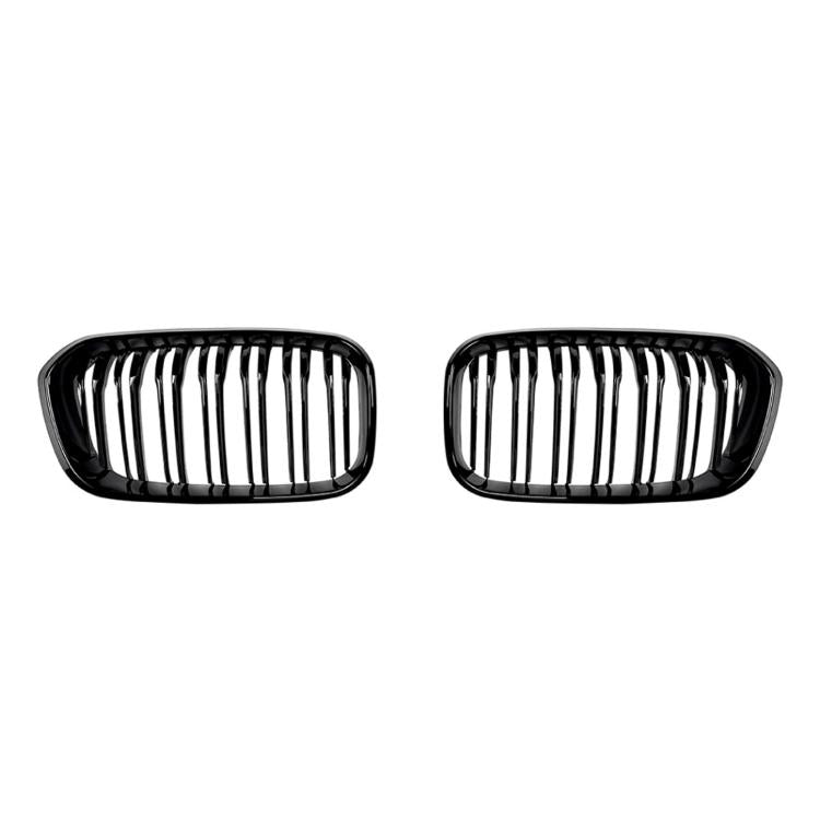Black oval front grille pair with vertical slats and dual-line center bars
