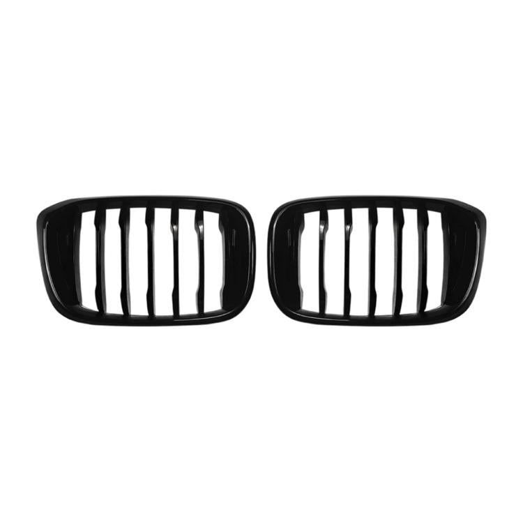 Pair of black oval front grille inserts with vertical slat openings