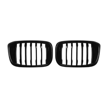 Pair of black oval front grille inserts with vertical slat openings