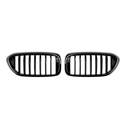 Pair of black front grille inserts with vertical slat bars, oval housing