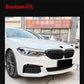 Front grille on a white car, black dual kidney-style inserts with vertical slats