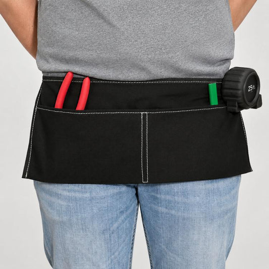 Black canvas half apron with waist ties and front pocket compartments