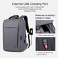 Gray laptop backpack with external USB charging port and attached charging cable