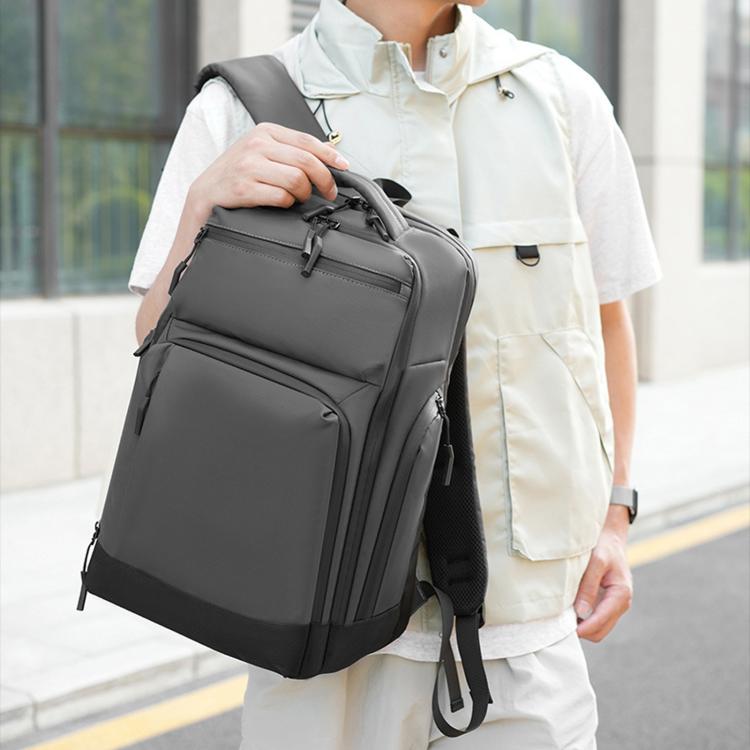 Dark gray laptop backpack with front pocket and zip compartments, worn on back
