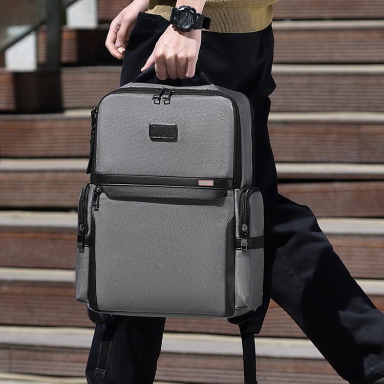 Gray 15.6-inch laptop backpack with front flap pocket and side zippers