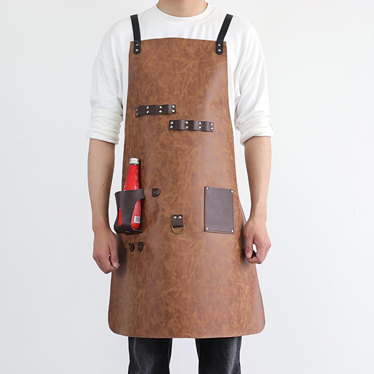 Light brown waterproof BBQ apron with studded leather strap details and bottle holster