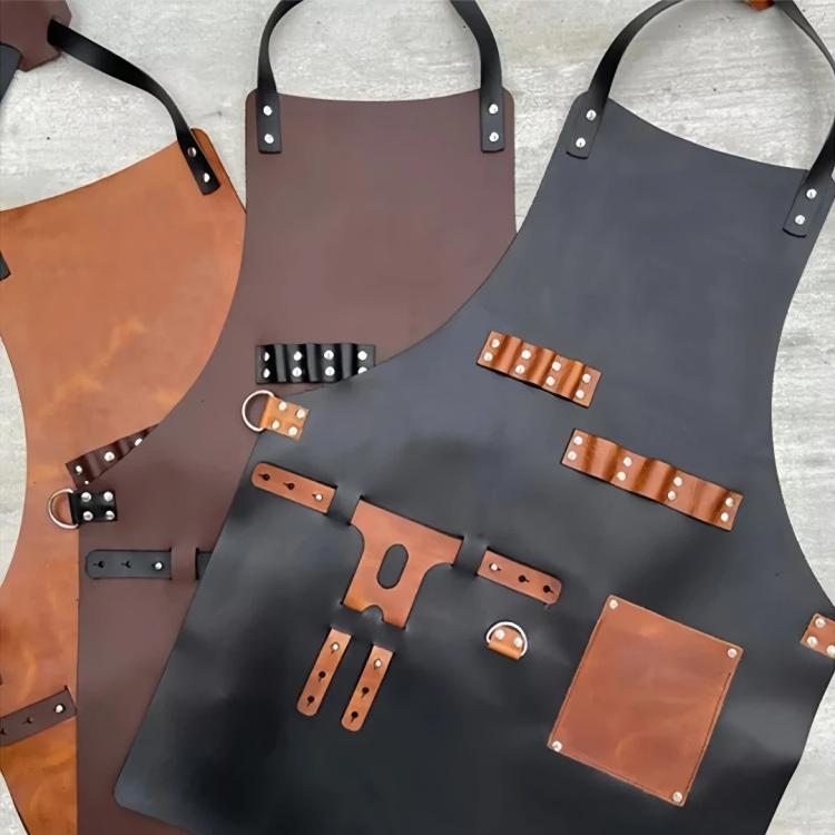 Assorted waterproof BBQ aprons with tan leather panels, straps, and bottle holders