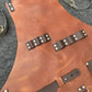 Close-up of tan waterproof BBQ apron with metal-studded leather strap accents