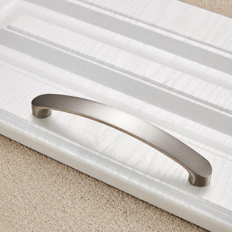 Curved brushed metal cabinet pull with smooth arch shape and two mounting end caps