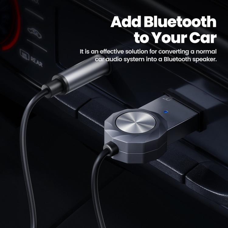 Bluetooth AUX adapter with 3.5mm jack connected to a car audio panel