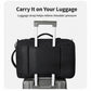 Black backpack with luggage pass-through strap for attaching to rolling luggage
