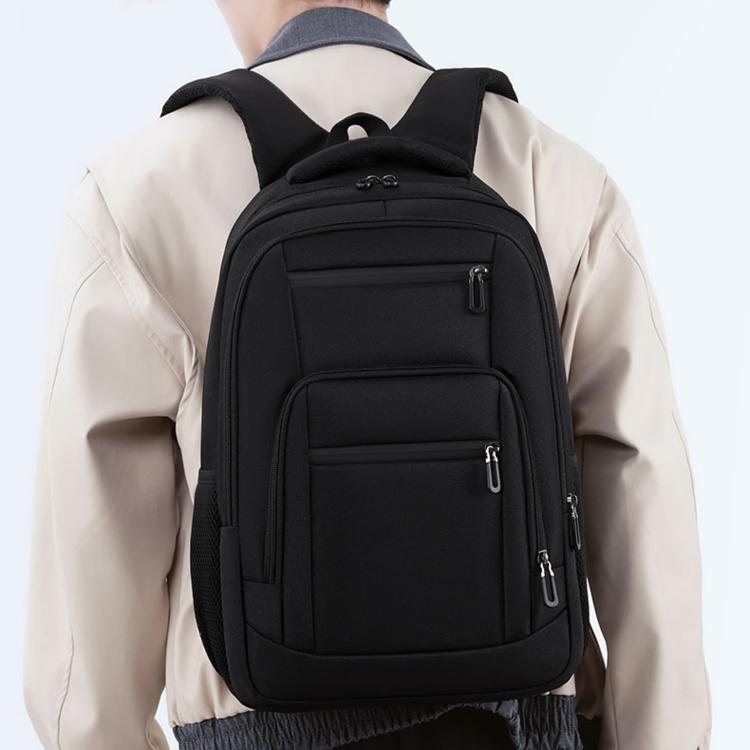 Black backpack worn on back; front and side zippers with padded shoulder straps