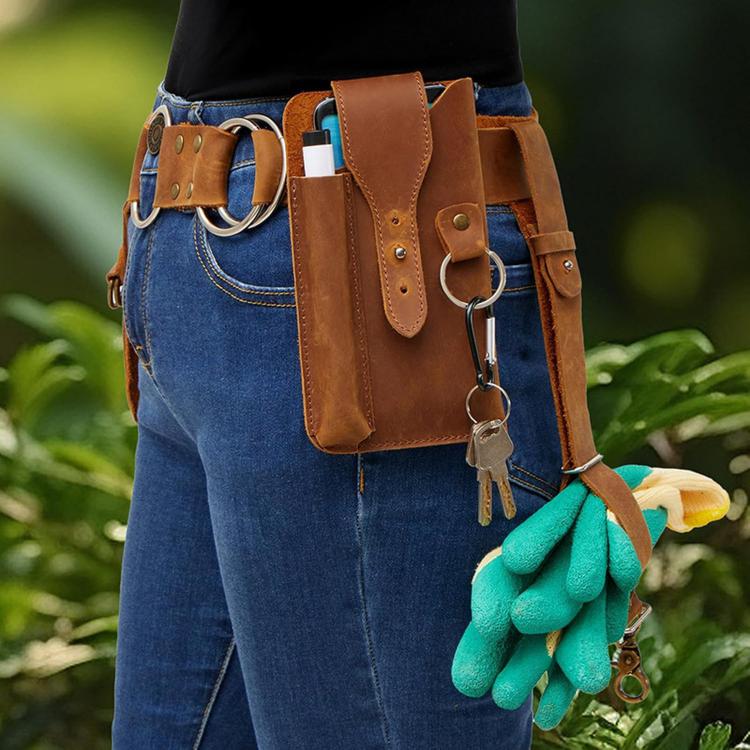 Brown leather tool waist bag worn with side pocket, flap holder, and hanging key ring