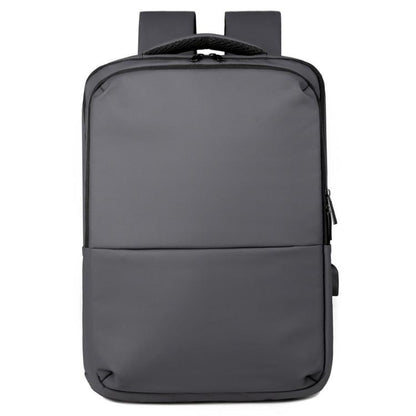 Laptop backpack with top handle, front zip pocket, and padded straps in gray
